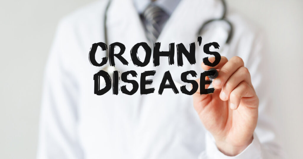 Doctor writing word Crohn's disease with marker, Medical concept
