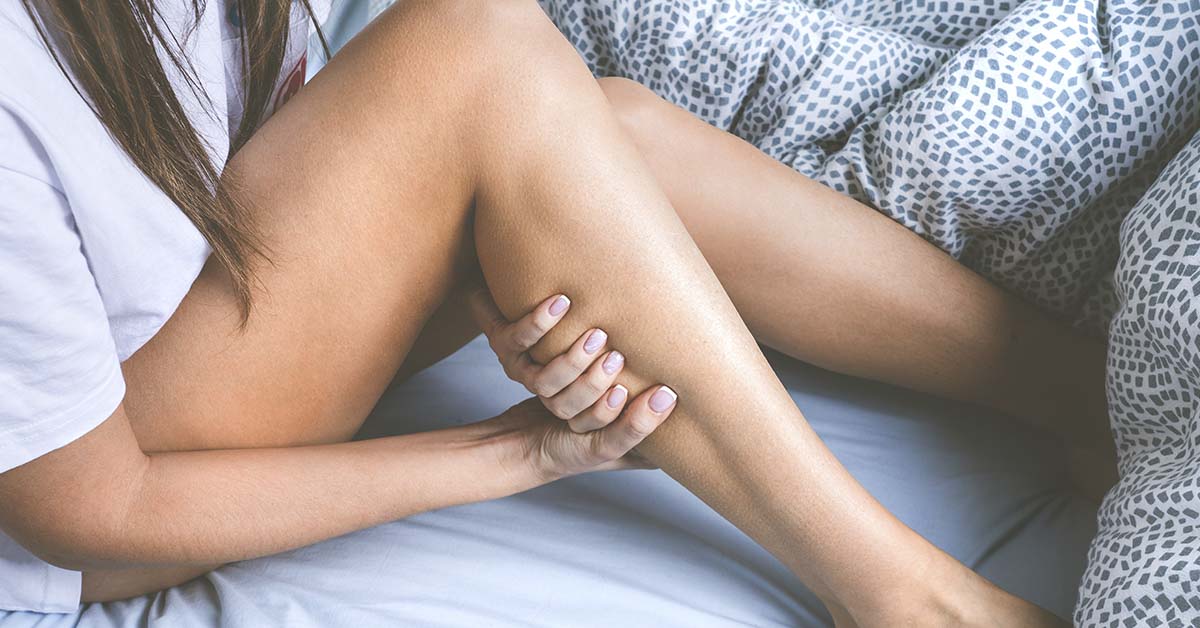 woman rubbing her calf. Leg cramp concept