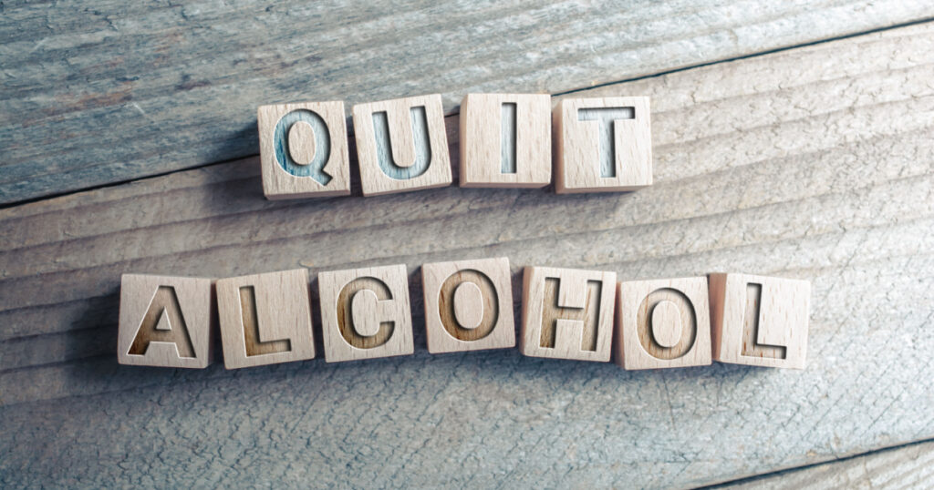 Quit Alcohol Written On Wooden Blocks On A Board - Reminder Concept
