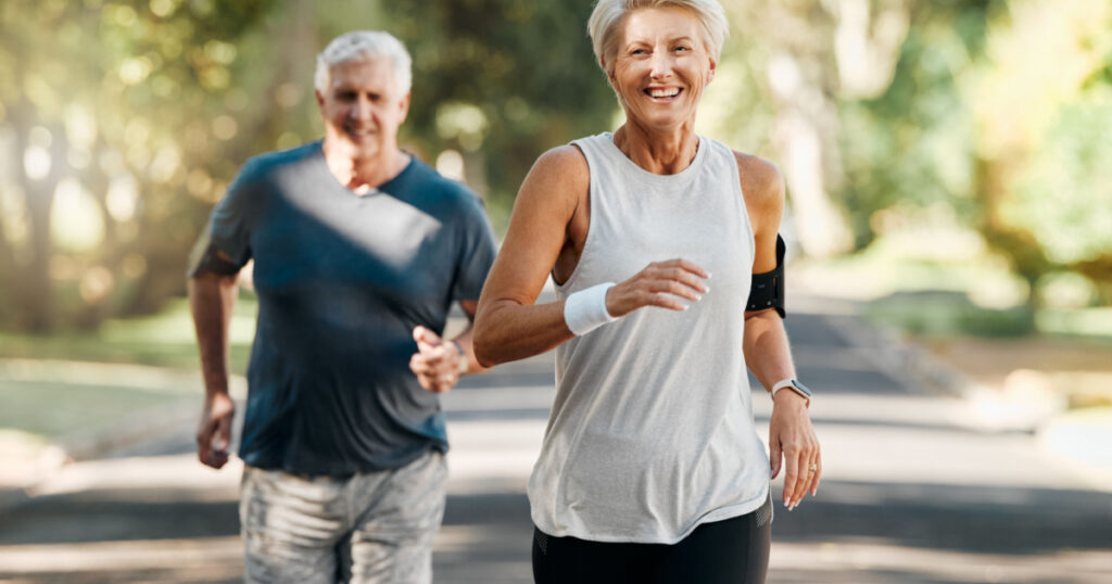 Retirement, couple and running fitness health for body and heart wellness with natural ageing. Married, mature and senior people enjoy nature run together for cardiovascular vitality workout.
