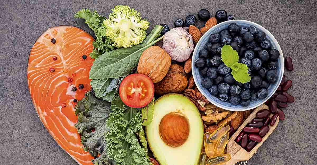 various heart healthy foods. Green vegetables, avocado, salmon, berries, etc.