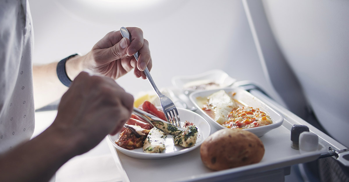 person eating an in-flight meal / airline food on a plane