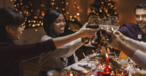 image of people gathered at the dinner table for the holidays