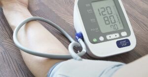 20 Best Foods To Help Lower Blood Pressure Without Medication someone using at home blood pressure measuring device