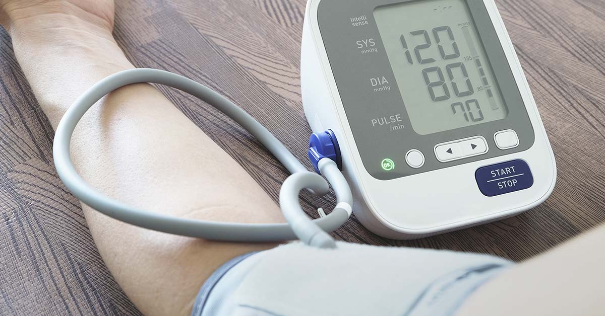 someone using at home blood pressure measuring device
