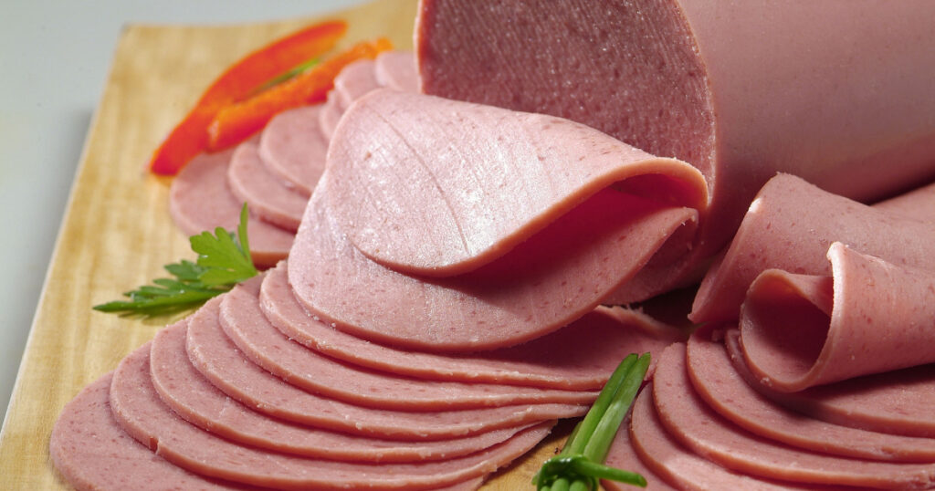 sliced bologna decorated with vegetables
