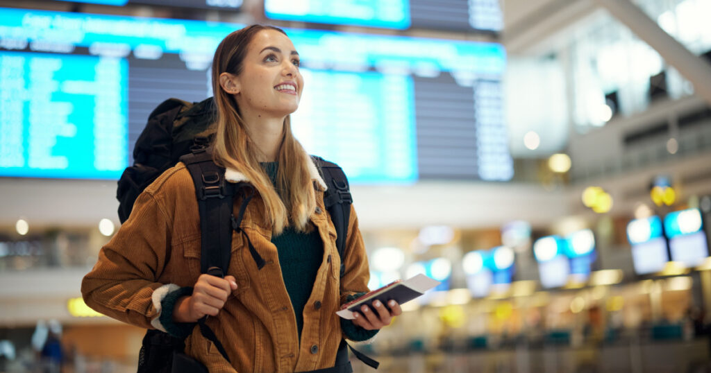 Travel, airport and excited woman with passport. travel ticket and documents for immigration, journey and flight schedule. Backpack person with identity document search for international registration
