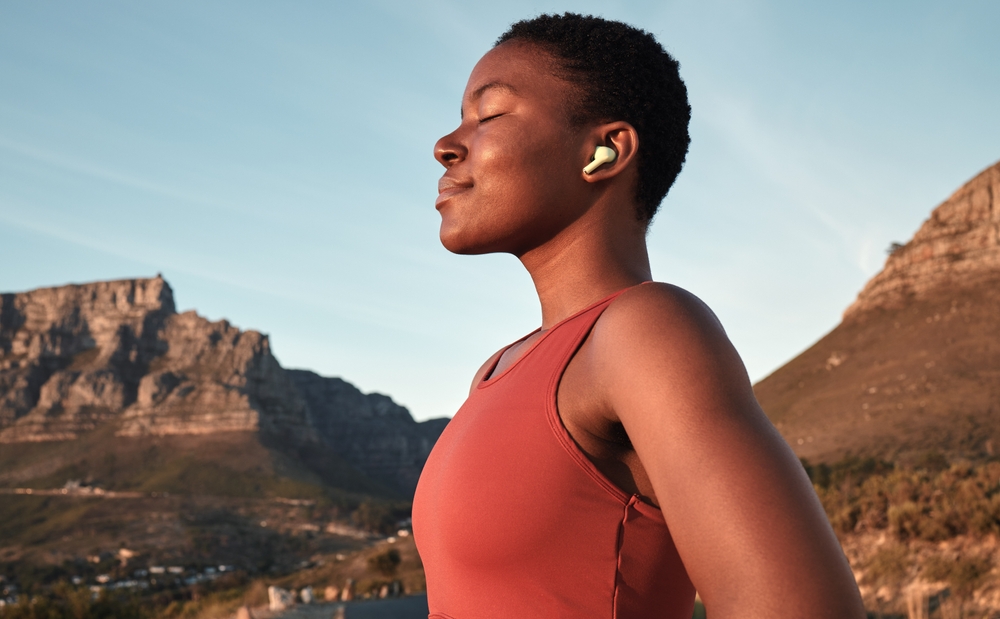 Calm black woman, outdoor fitness and breathing in nature, Cape Town mountains and meditation of motivation, health or relax mindset. Female athlete, breathe and workout peace for zen sports wellness