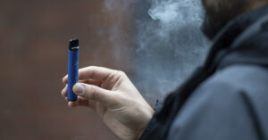 Dying Young? 22-Year-Old Vaping Addict Has a 1% Chance of Survival person holding vape pen.