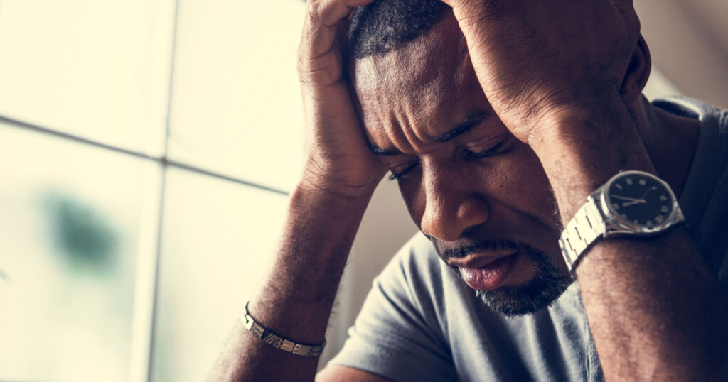 Black guy stressting and headache
