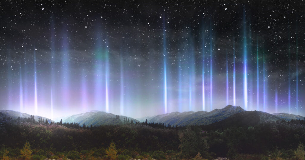 Beautiful colorful light pillars at night over the mountains
