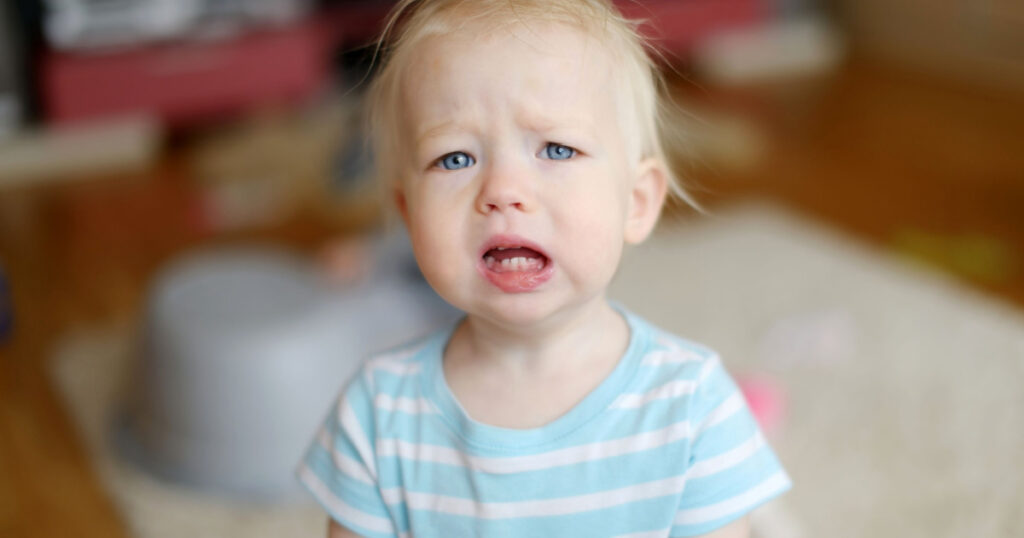 Angry upset toddler girl at home
