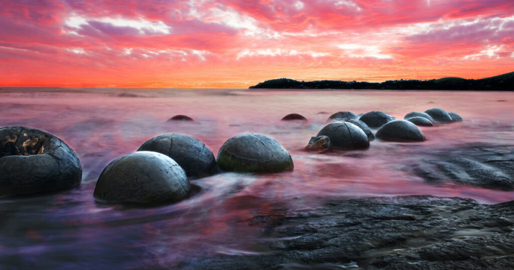 Moeraki Boulders on the Koekohe beach, Eastern coast of New Zealand. Sunset and long exposure
