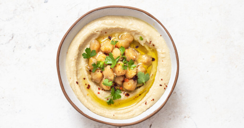 Classic hummus with parsley on a plate . Traditional hummus salad