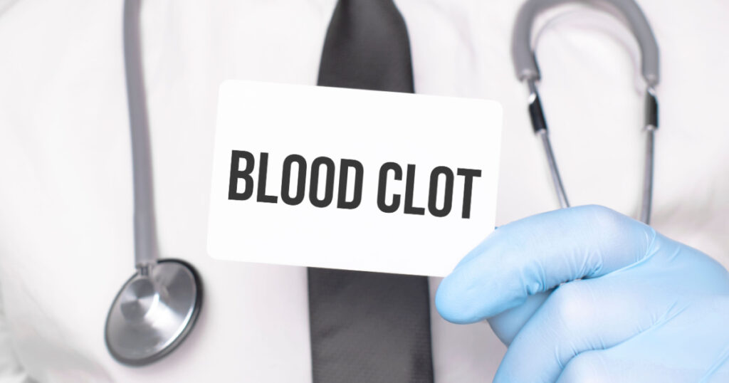 Doctor holding a card with text blood, clot,medical concept
