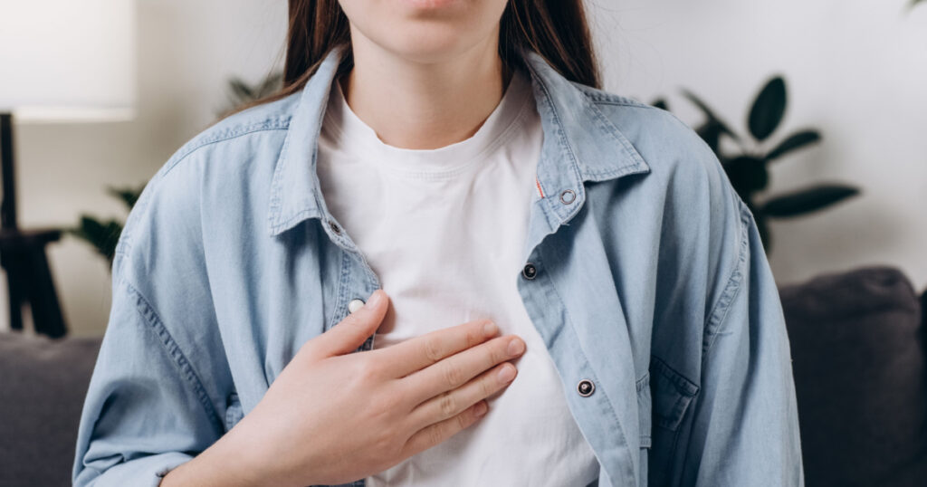 Cropped shot unhealthy sad caucasian woman having or symptomatic reflux acids, Gastroesophageal reflux disease, Because the esophageal sphincter separates the esophagus. Stomach dysfunction concept
