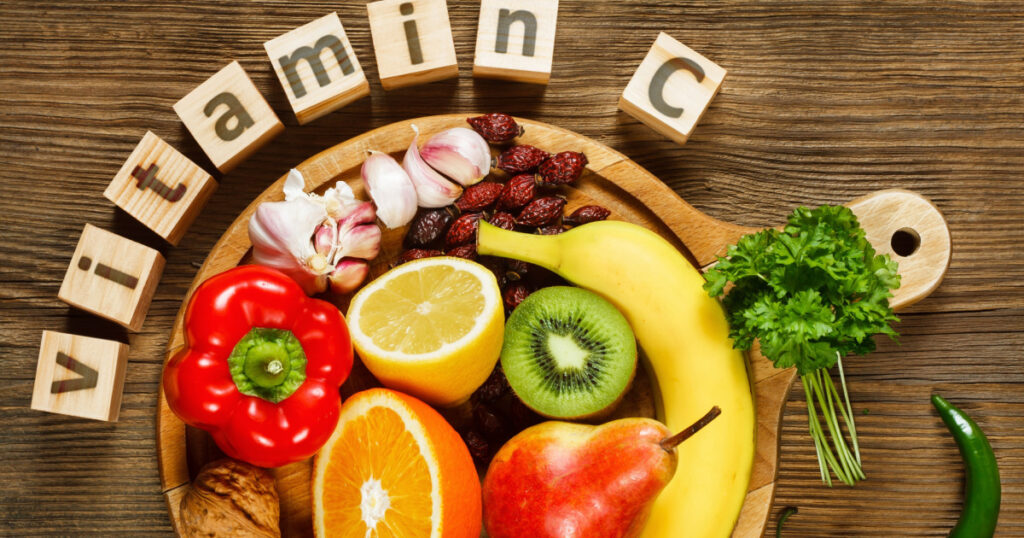 Vitamin C in fruits and vegetables. Natural products rich in vitamin C as oranges, lemons, dried fruits rose, red pepper, kiwi, parsley leaves, garlic, bananas, pears, apples, walnuts, chili.
