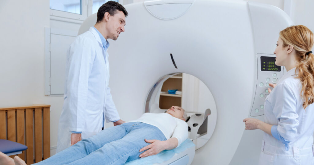 Positive experienced doctor doing brain tomography