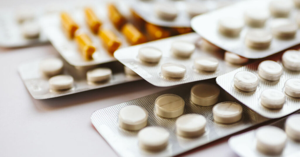 Different medicines: tablets, pills in blister pack, medications drugs, macro, selective focus, copy space
