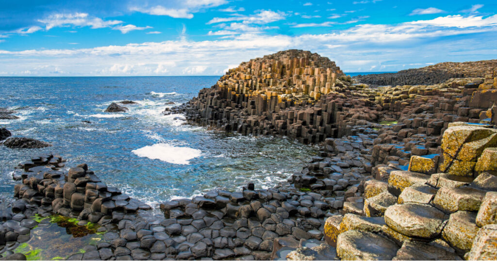 Landscape of Giant's Causeway trail with a blue sky in summer in Northern Ireland in United Kingdom. UNESCO heritage.
