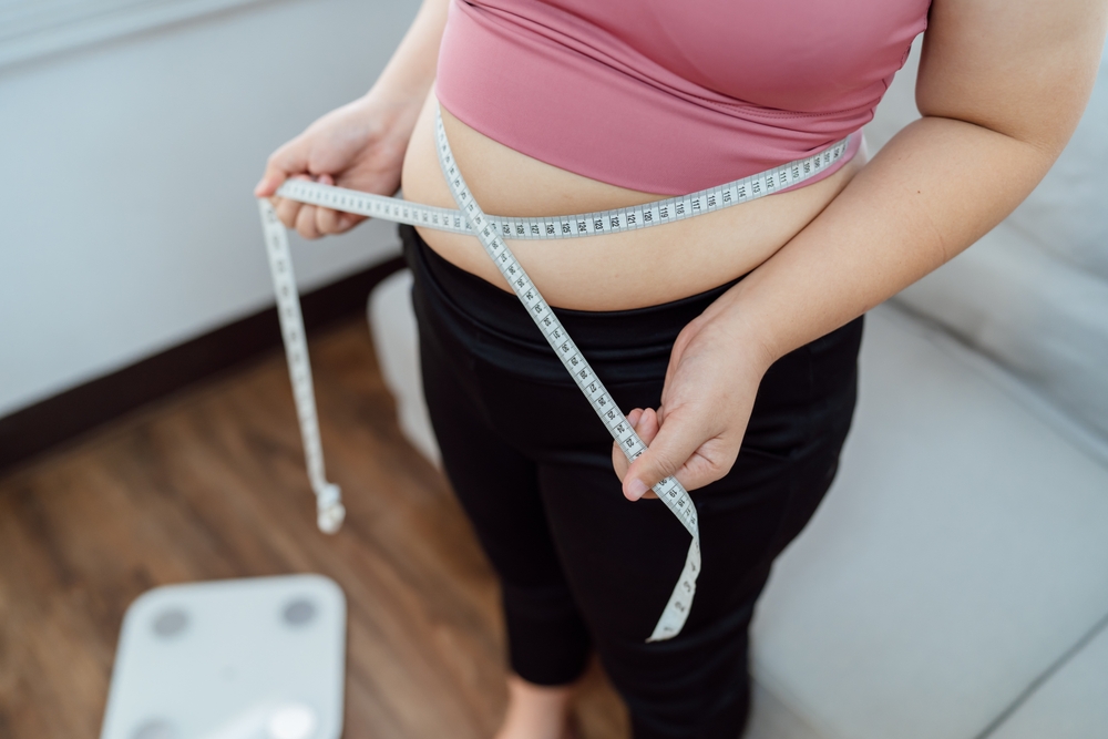 Obese Woman with fat upset about her belly. Overweight woman touching his fat belly and want to lose weight. Fat woman worried about weight diet lifestyle.