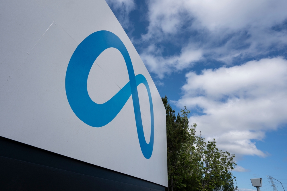 Menlo Park, CA, USA - Apr 30, 2022: Closeup of the Meta sign against dramatic clouds in the blue sky seen at the Meta Platforms headquarters in Menlo Park, California.