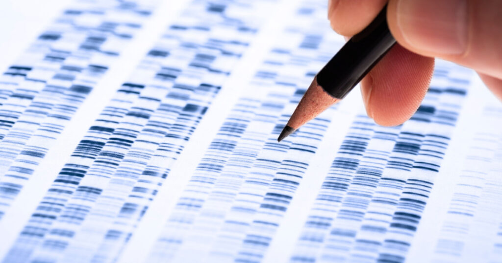 Scientist analyzes DNA gel used in genetics, forensics, drug discovery, biology and medicine.