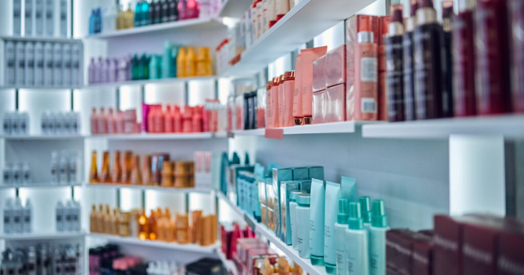 Modern beauty salon interior. Different cosmetics on shelves.
