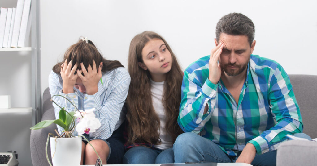Trouble couple with unhappy child teenager discussing problems in worry family. Conflicts marital sad couple with kids crisis.