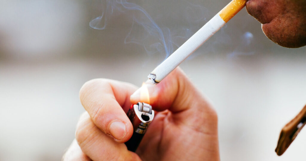 a young man smoking a cigarette