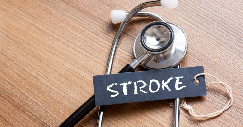 Medical Concept-Stroke word written on label tag with Stethoscope on wood background