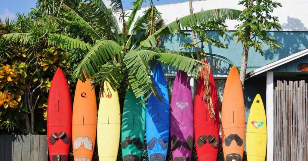 PAIA, HI -30 MARCH 2016: Colorful surfboards are lined up in the streets of Maui. Hawaii is the birthplace of modern surfing and home to the world's major big wave surfing competitions.