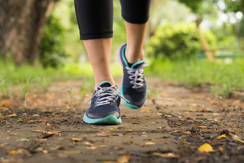 female runner feet closeup outdoor during running workout exercise. Health, fitness and excercise concept.