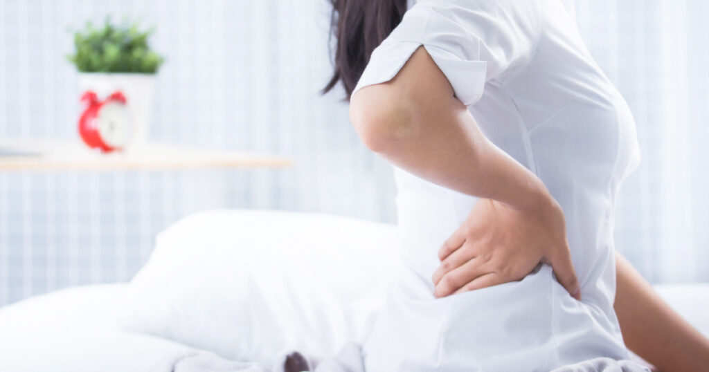 Woman problem Chronic back pain on bed morning time