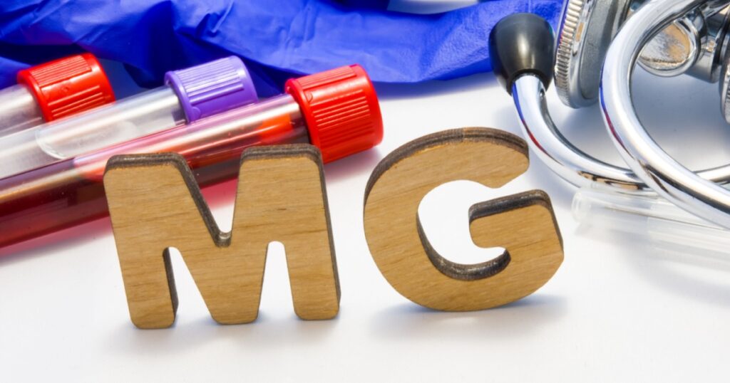 MG abbreviature mean Magnesium electrolyte with lab tubes with blood and stethoscope. Using acronym MG in laboratory clinical diagnosis, determination of pathologies contacts to deficiency