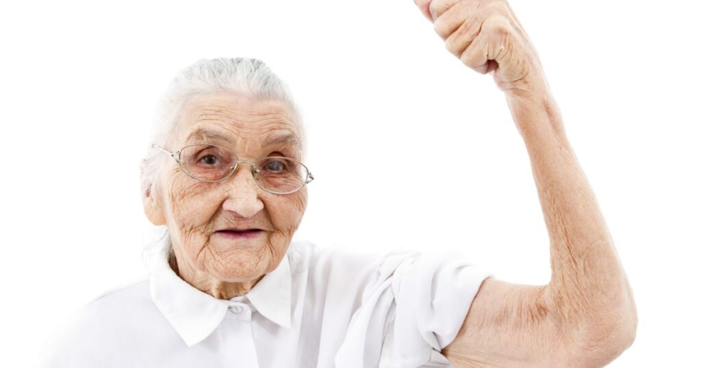 very old woman showing her muscles on her arms
