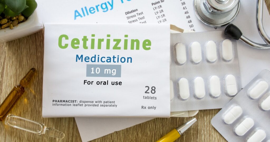 KYIV, UKRAINE-MAY 22, 2019: Cetirizine medication or allergy drug concept photo. On doctor table is pack with words "Cetirizine medication" and pills for treatment of allergy and hypersensitivity