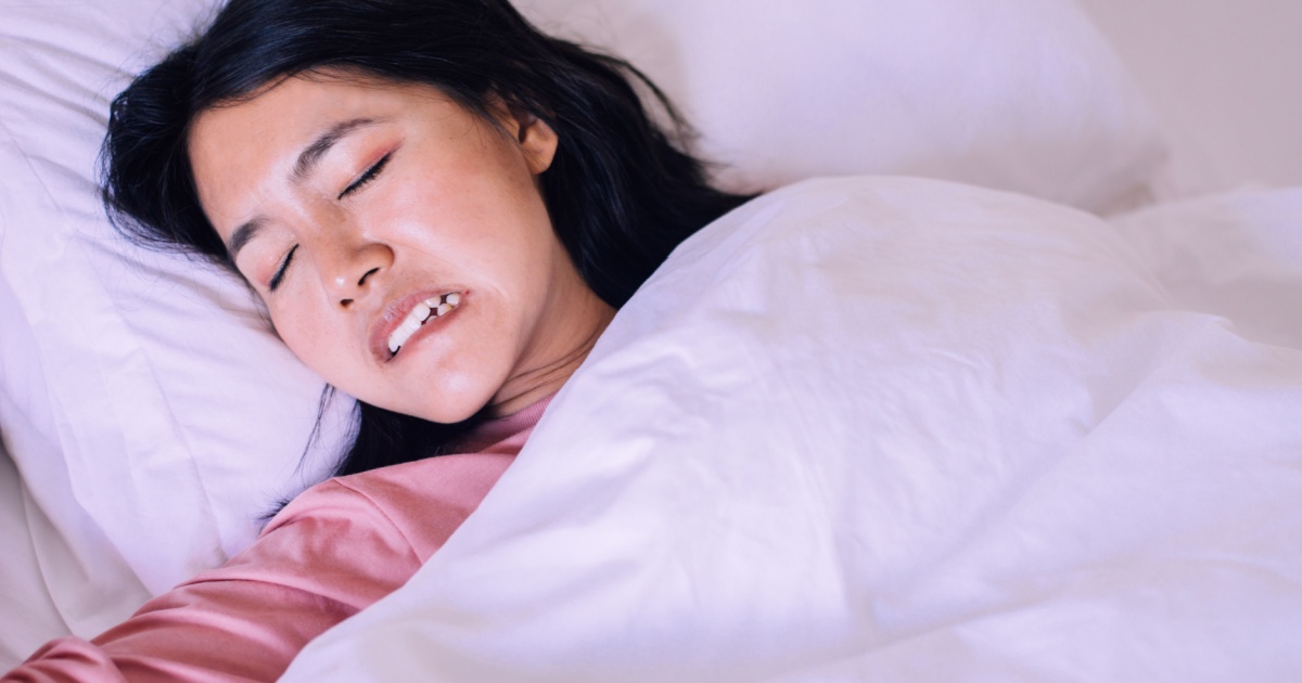 Asian woman sleeping and grinding teeth in bedroom,Female tiredness and stress