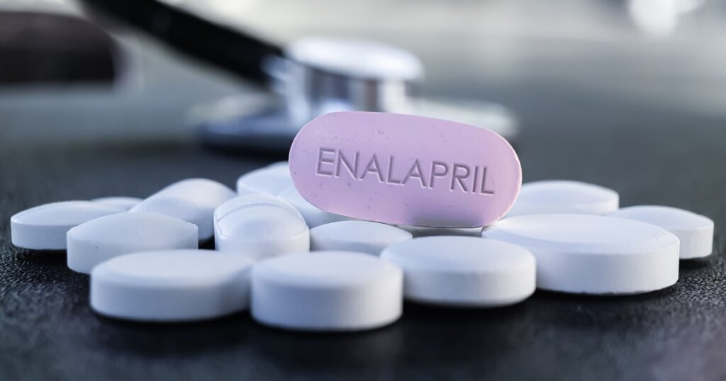 Enalapril Pill Medication to treathigh blood pressure, diabetic kidney disease and heart failure. Drug Therapy for Hypertension with stethocope in background on dark texture table