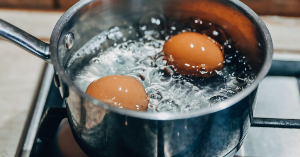 Saucepan with boiling eggs on a gas stove