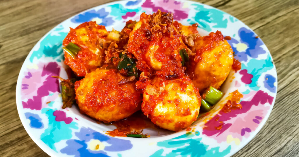 Balado Egg, an original Indonesian Recipe that Stir-fried hard-boiled eggs with Asian herbs and spices that have a strong, slightly spicy flavor.