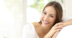 9 Ways You Can Whiten Teeth Naturally Beauty woman with white perfect smile looking at camera at home