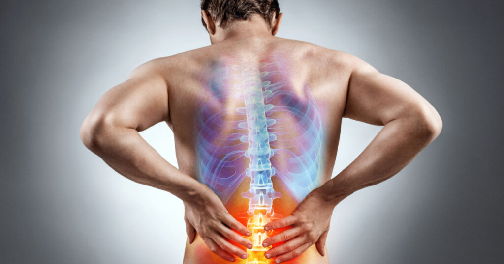 Lower back pain. Man holding his back in pain. Medical concept.