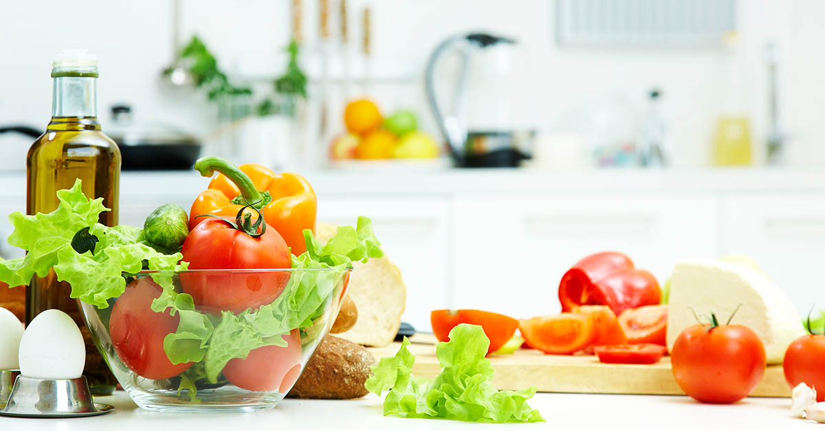 fresh vegetables in a white kitchen setting