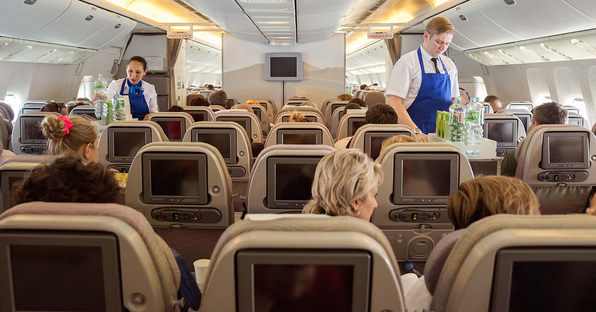 passengers being served by flight attendants during flight