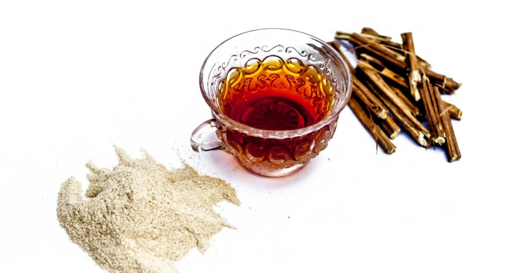 Ashwagandha roots and its powder also known as Indian ginseng, isolated on white essential beneficial for hair loss with its organic tea made from its powder.