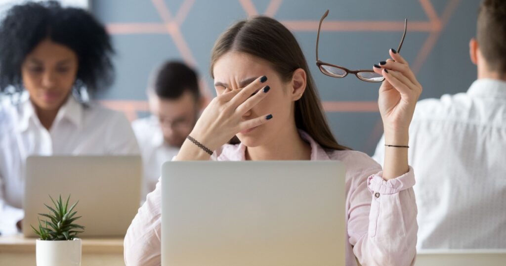 Young woman taking off glasses tired of computer work, exhausted student or employee suffering from eye strain tension or computer blurry vision problem after long laptop use, eyes fatigue concept