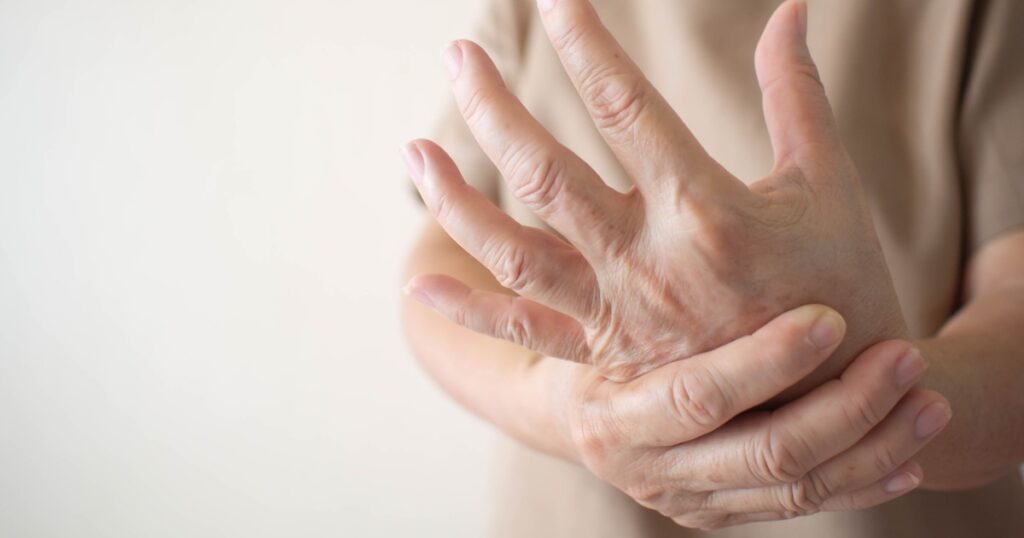 Elderly woman suffering from pain, numbness or weakness in hands. Causes of hurt include osteoarthritis, rheumatoid arthritis, gout, peripheral neuropathy, lupus or Raynaud’s phenomenon. Health care.