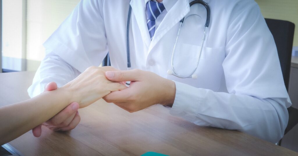 doctor touching hand patient to check wrist bone after broken in hospital.