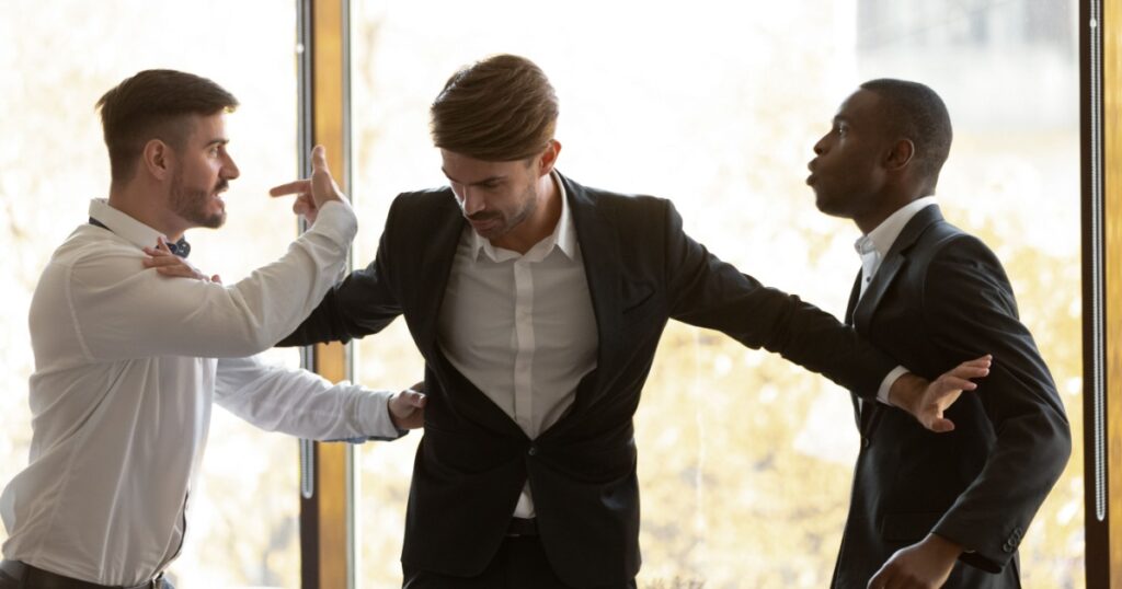 Male colleague set apart angry